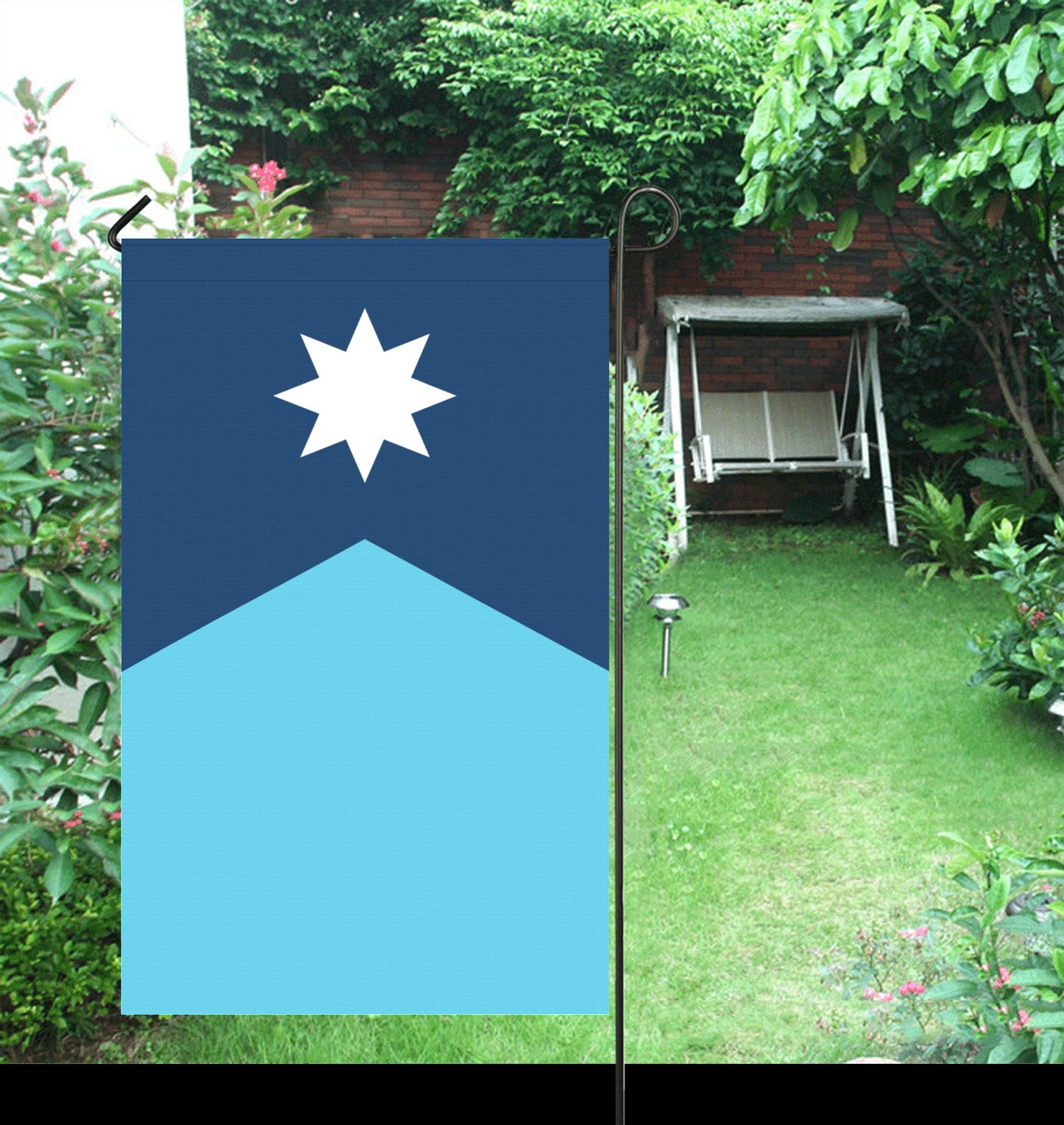 Luv My Flag: Blue flag in lush garden setting.