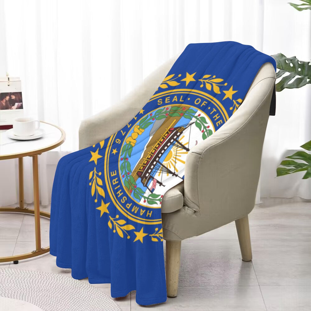 Blue blanket with New Hampshire seal on a chair. Luv My Flag.