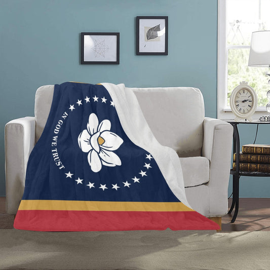 Luv My Flag blanket draped over sofa in cozy room.