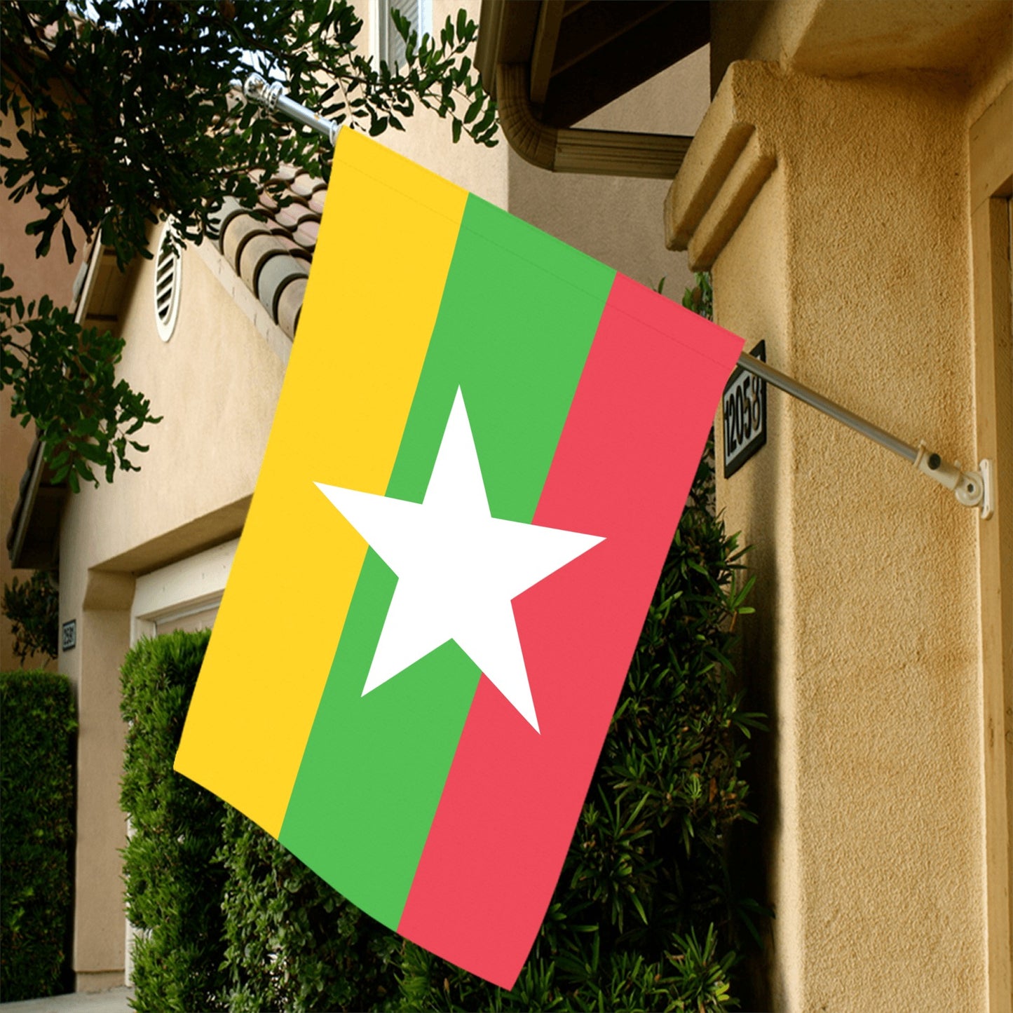 Luv My Flag hanging outside house, featuring colorful stripes.