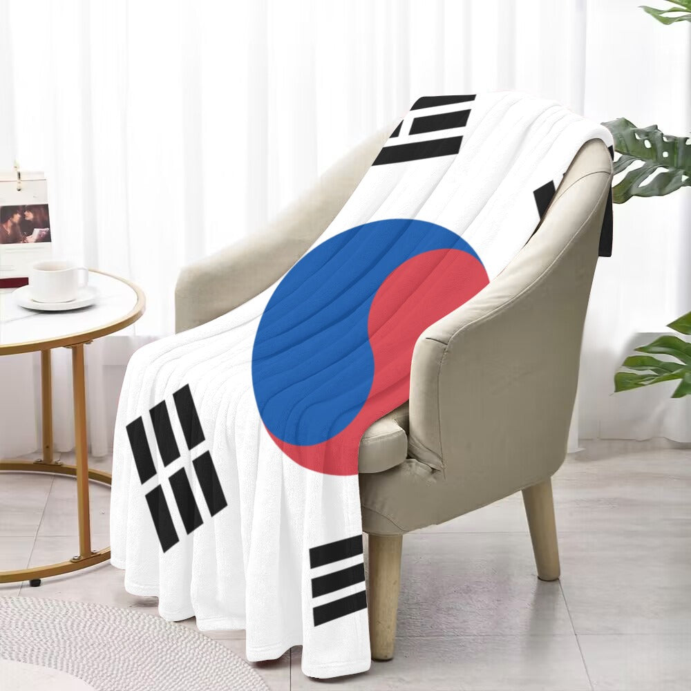 Luv My Flag blanket on chair with South Korean design.