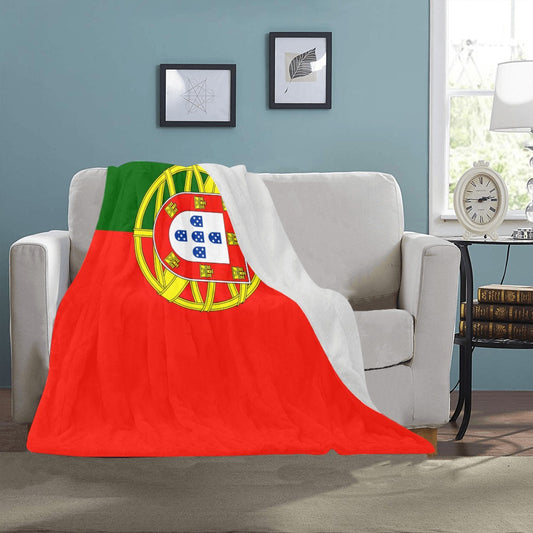Cozy sofa with Luv My Flag Portugal-themed blanket draped.