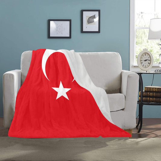 Luv My Flag blanket with Turkish design on sofa.