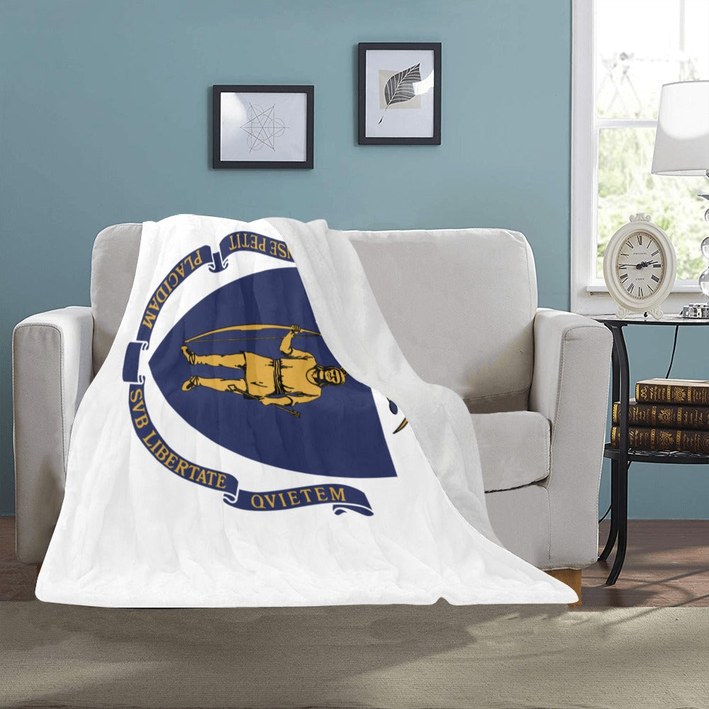 Cozy blanket with Massachusetts flag, draped on sofa. Luv My Flag.