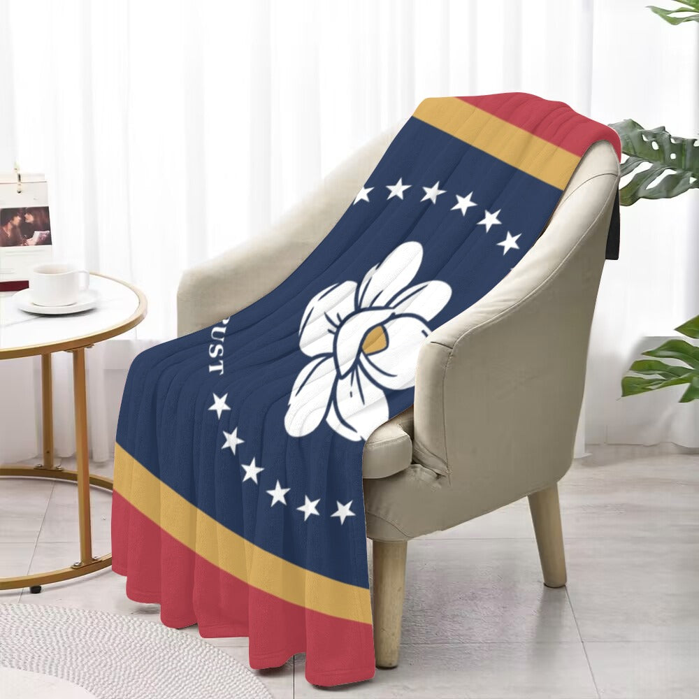 Cozy chair with Luv My Flag floral-themed blanket.