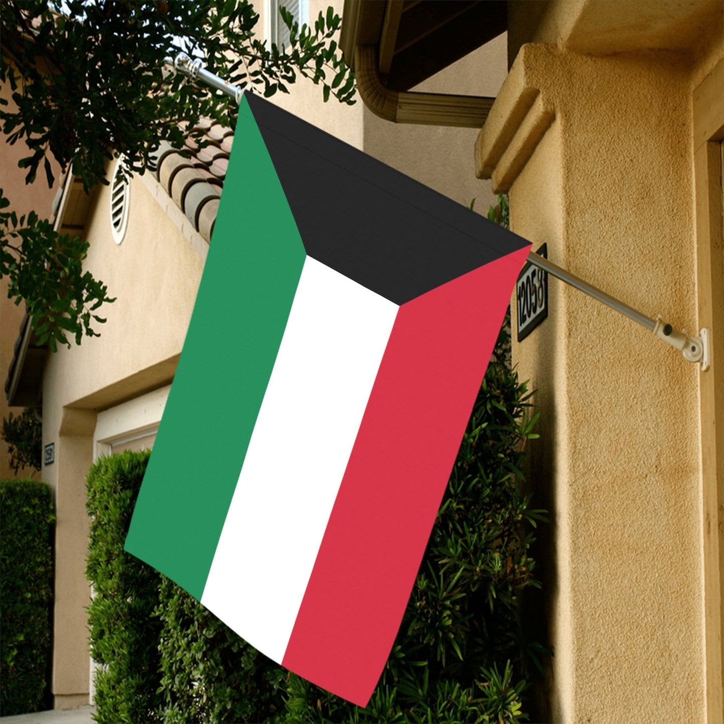 Luv My Flag Kuwait flag displayed on house exterior wall.