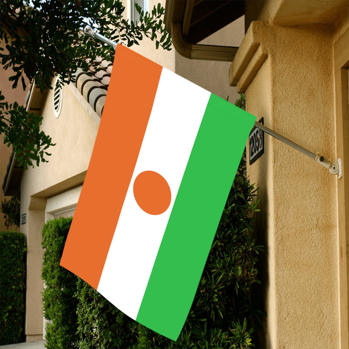 Flag of Niger by Luv My Flag, displayed outside house.