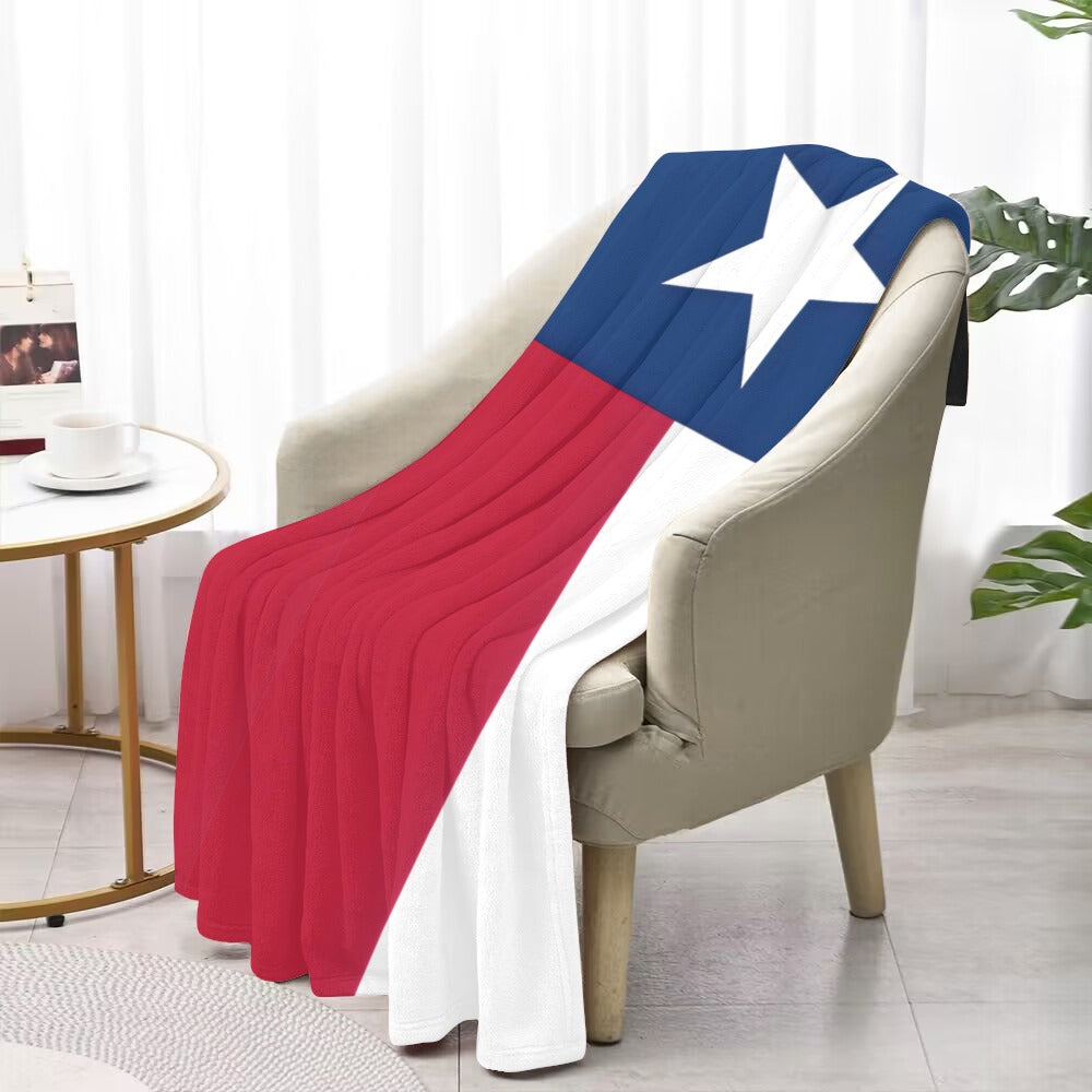 Luv My Flag Texas-themed blanket draped over beige chair.