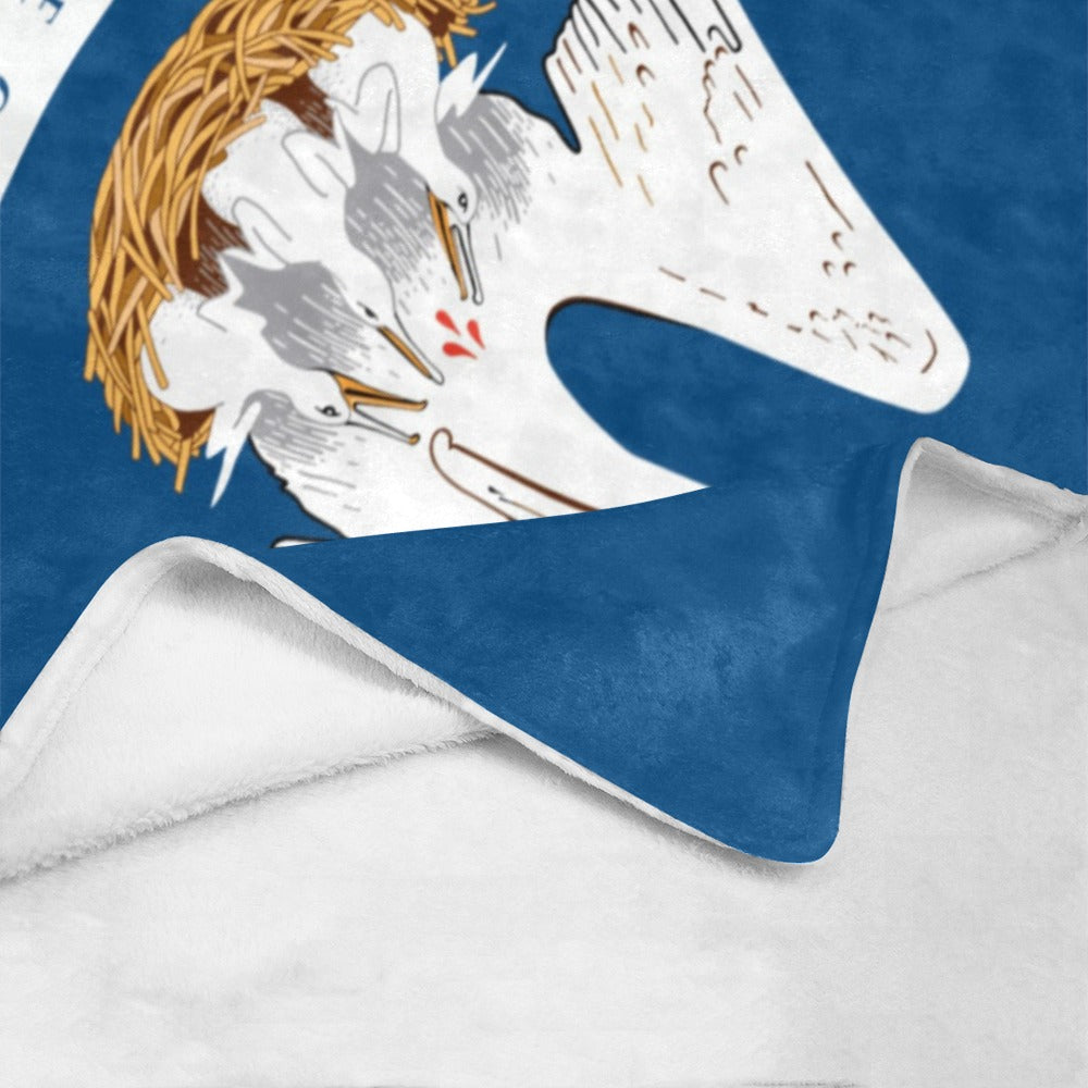 Blue blanket featuring birds in nest design, Luv My Flag.