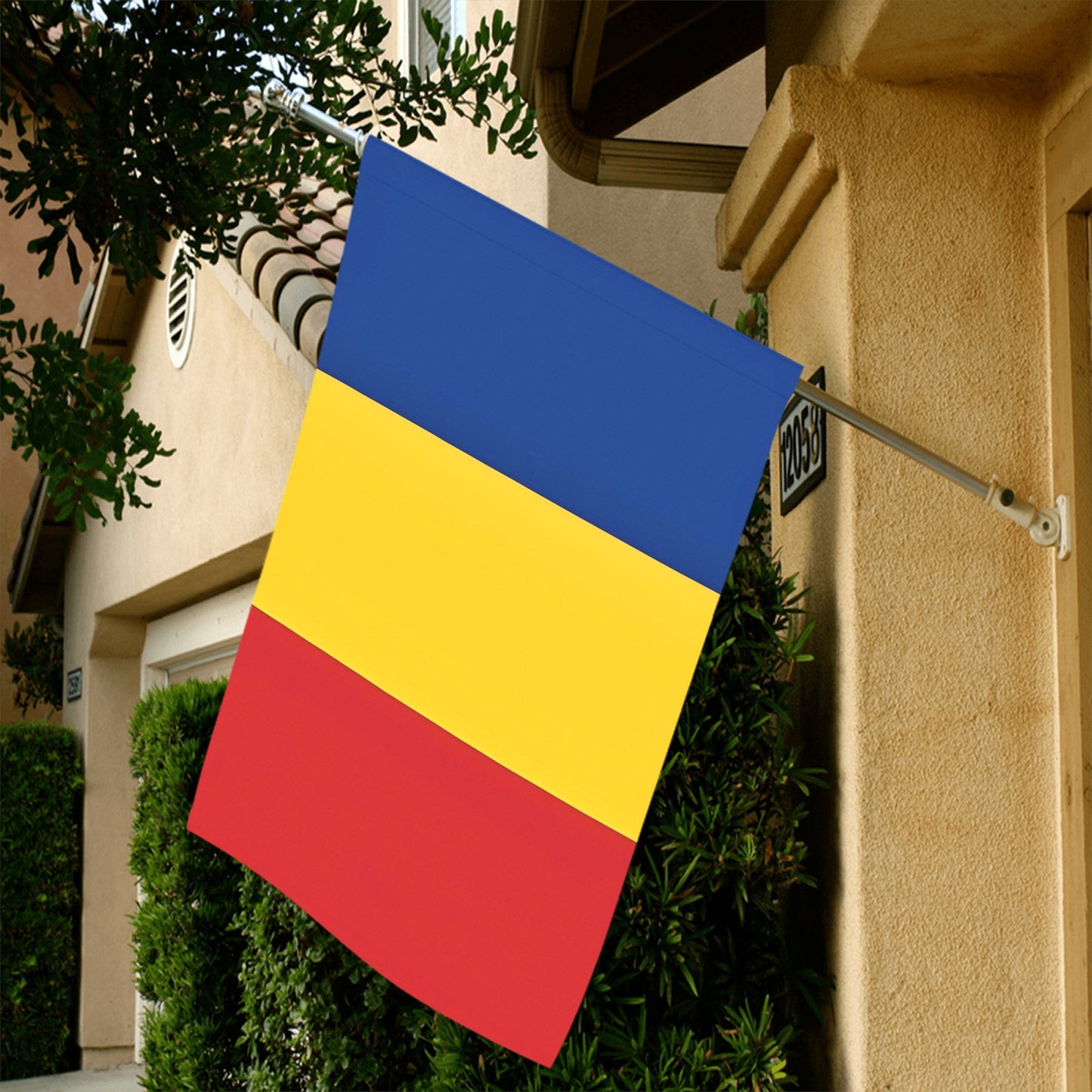 Luv My Flag: Tricolor flag on beige house exterior wall.