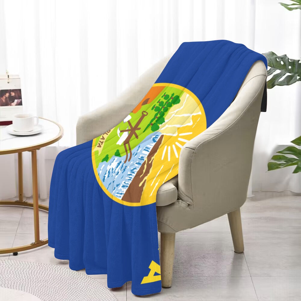 Luv My Flag blanket on chair with vibrant design.