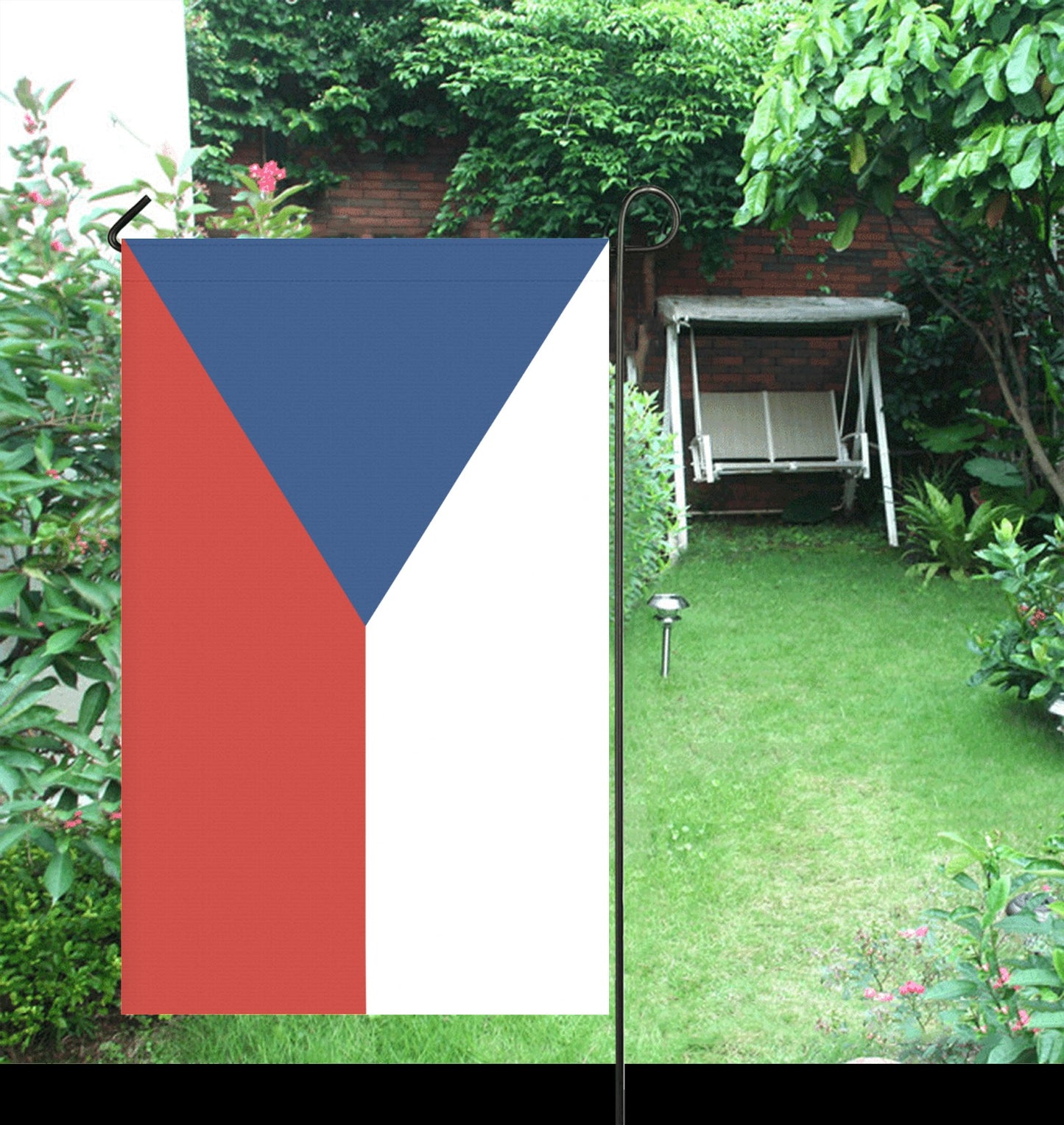 Garden with Luv My Flag displayed, near swing bench.