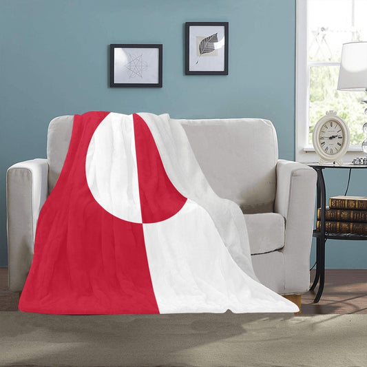 Red and white Luv My Flag blanket on sofa.