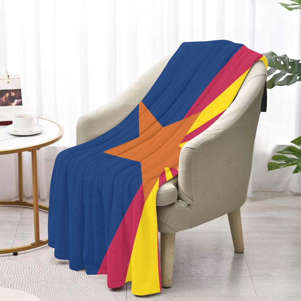 Colorful "Luv My Flag" blanket with star pattern on chair.