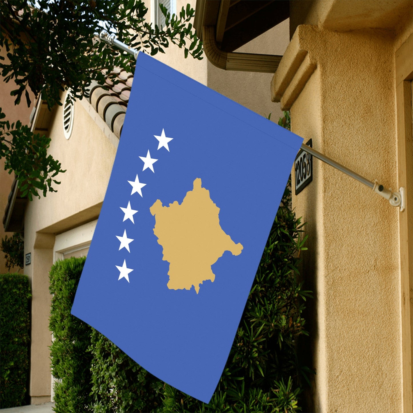 Luv My Flag Kosovo flag hanging on house wall.