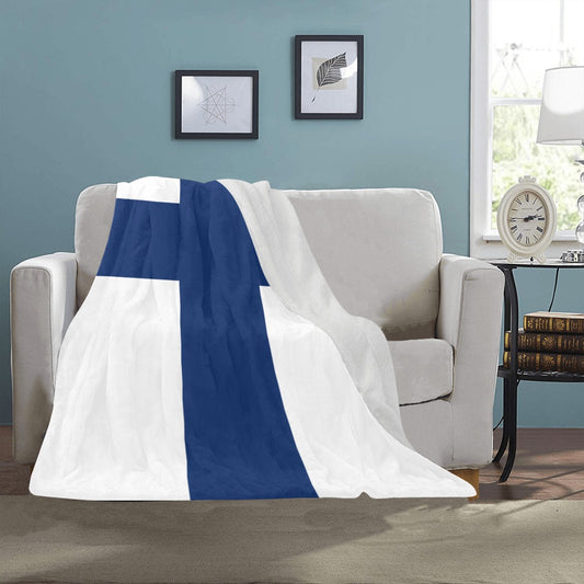 Luv My Flag Finland-themed blanket draped over beige sofa.