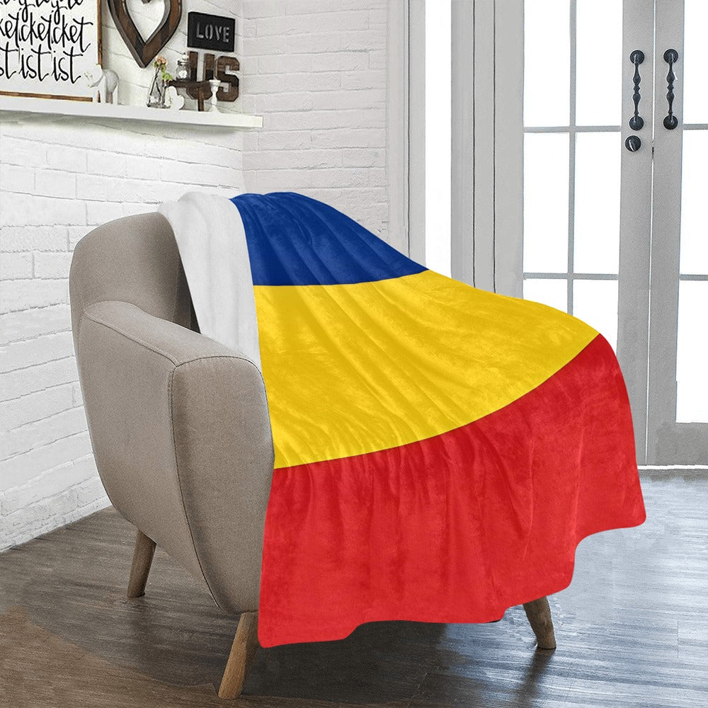 Cozy chair with Luv My Flag blanket, tricolor design.