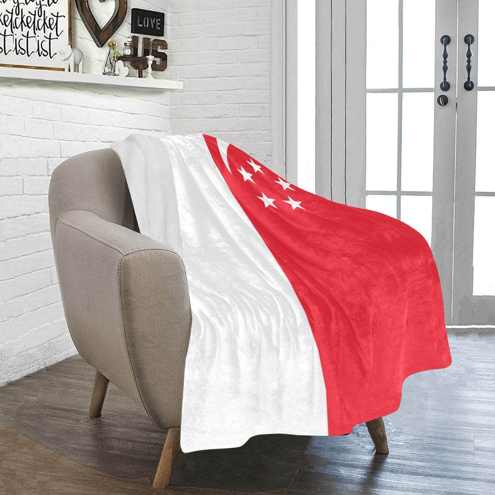 Luv My Flag Singapore blanket draped over beige chair.