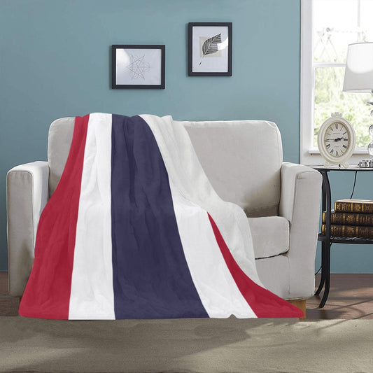 Luv My Flag blanket draped over sofa in cozy room.