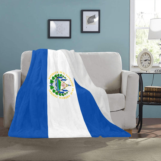 Luv My Flag blanket with El Salvador design on sofa.