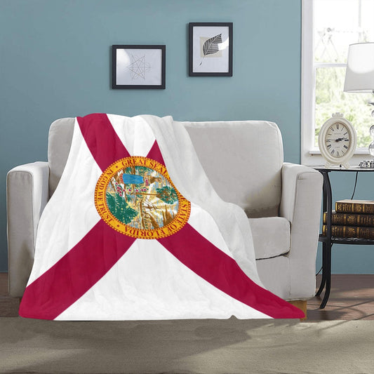 Luxurious couch draped with Luv My Flag Florida blanket.