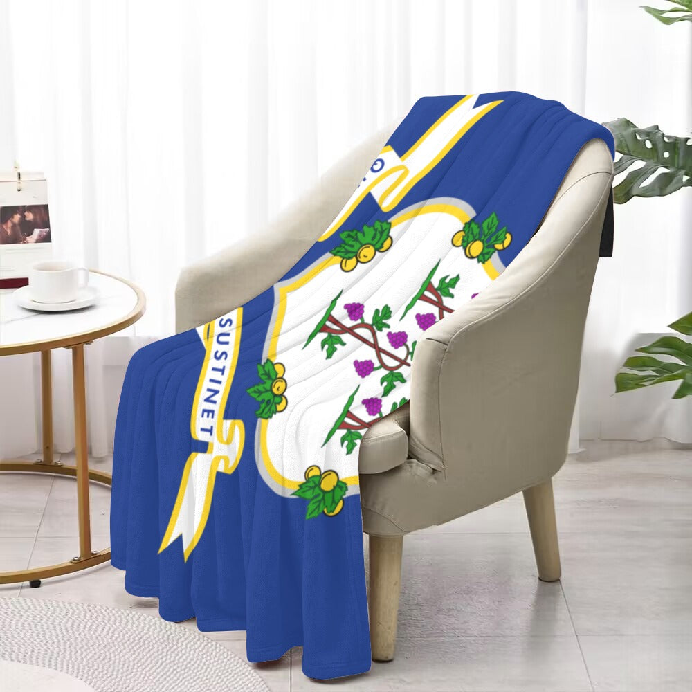 Cozy chair draped with Luv My Flag Connecticut blanket.