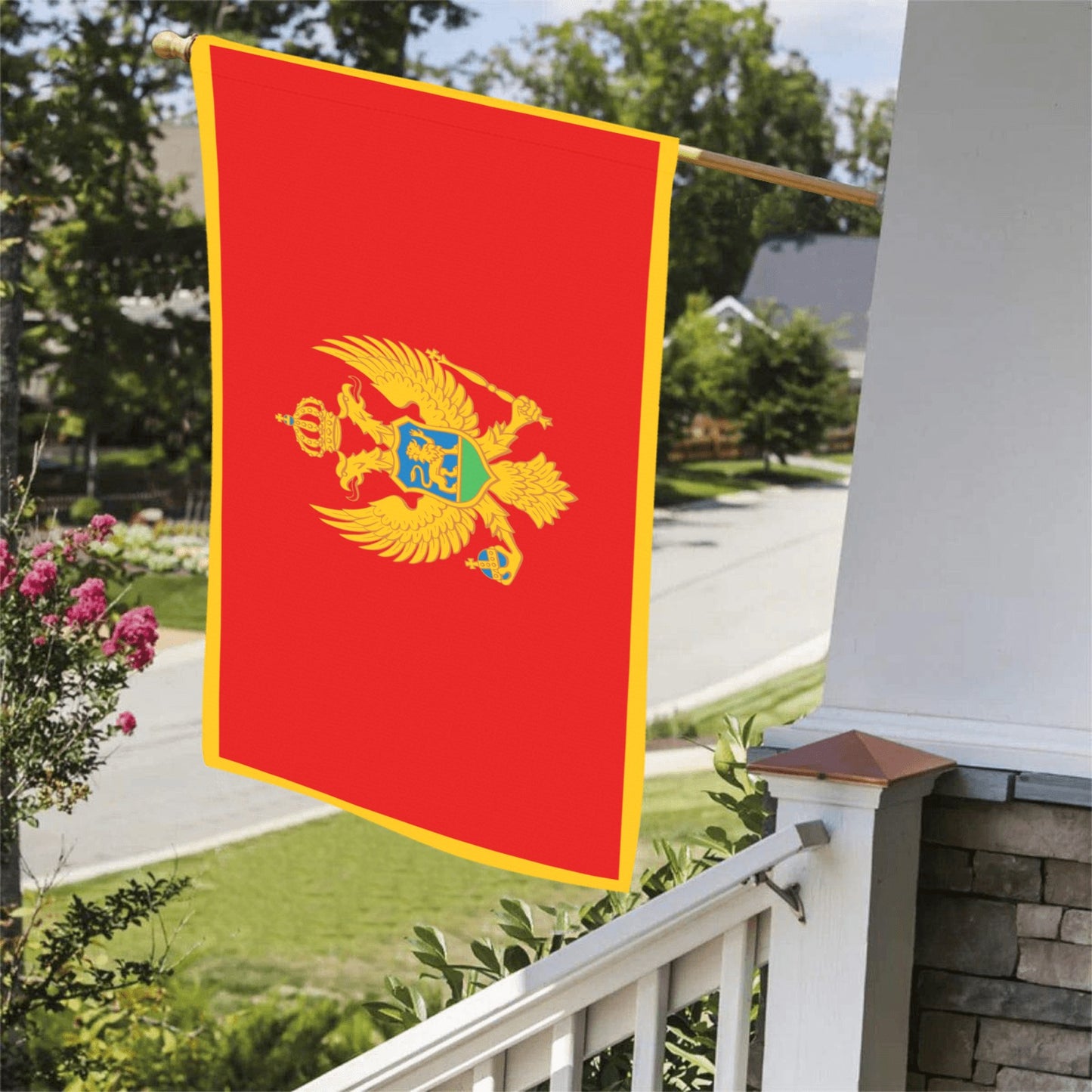 Red flag with crest, displayed outdoors by Luv My Flag.