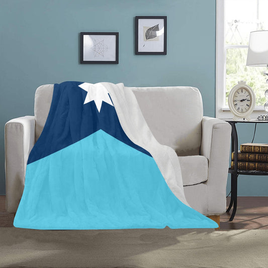 Cozy blue blanket on sofa, Luv My Flag brand.