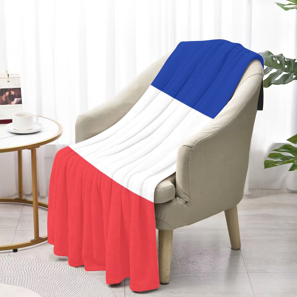 Luv My Flag patriotic blanket on beige armchair, indoors.
