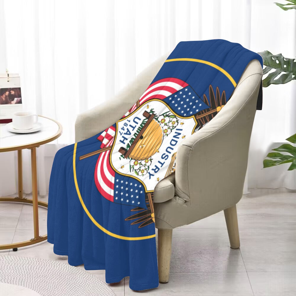 Cozy chair draped with Luv My Flag Utah blanket.