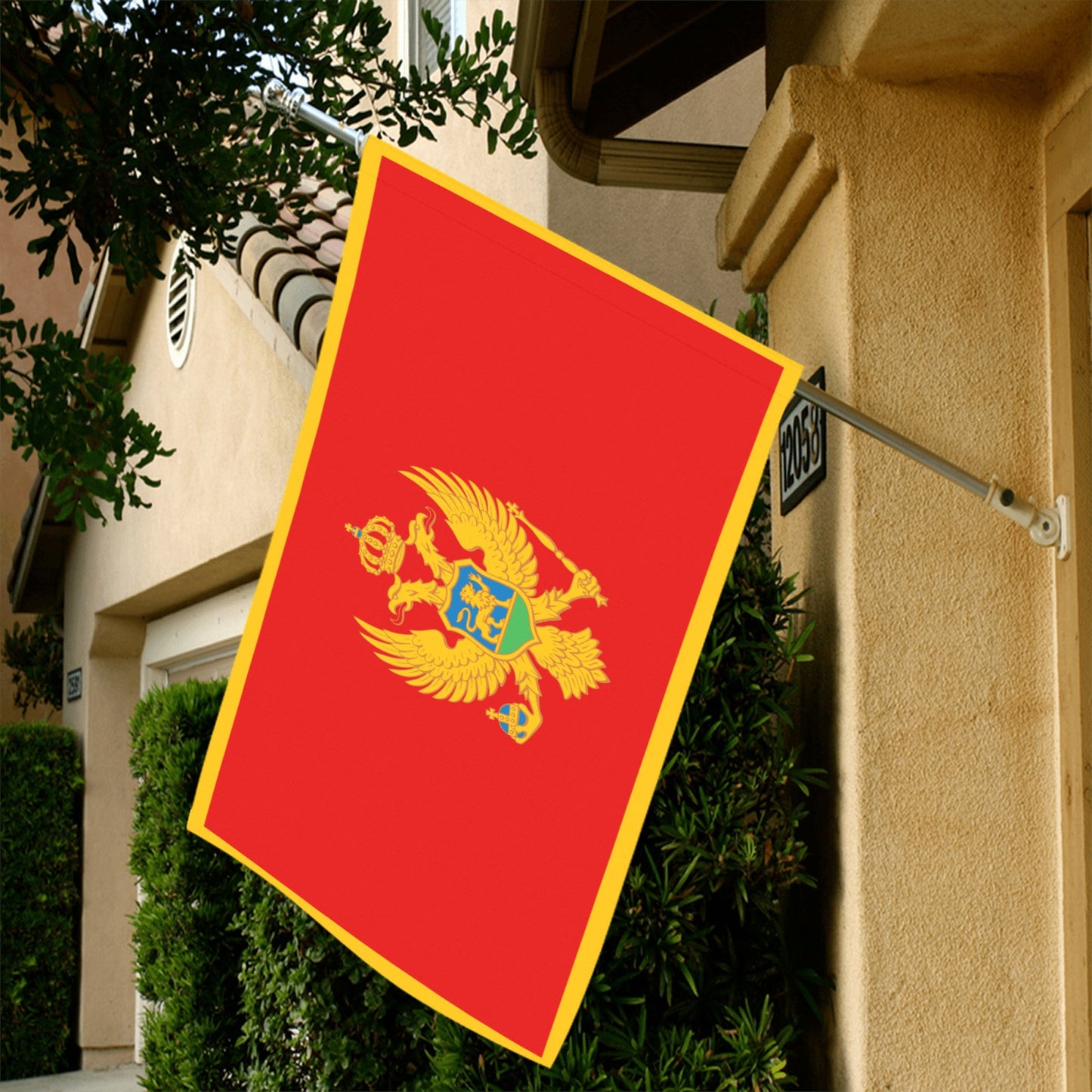 Red and gold flag displayed outdoors, branded Luv My Flag.