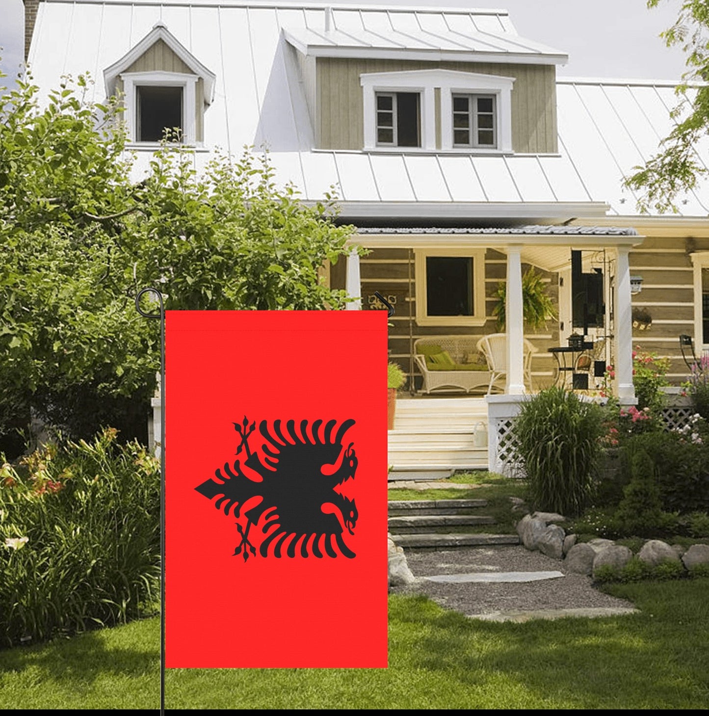 Red flag with black eagle outside rustic home. Luv My Flag.