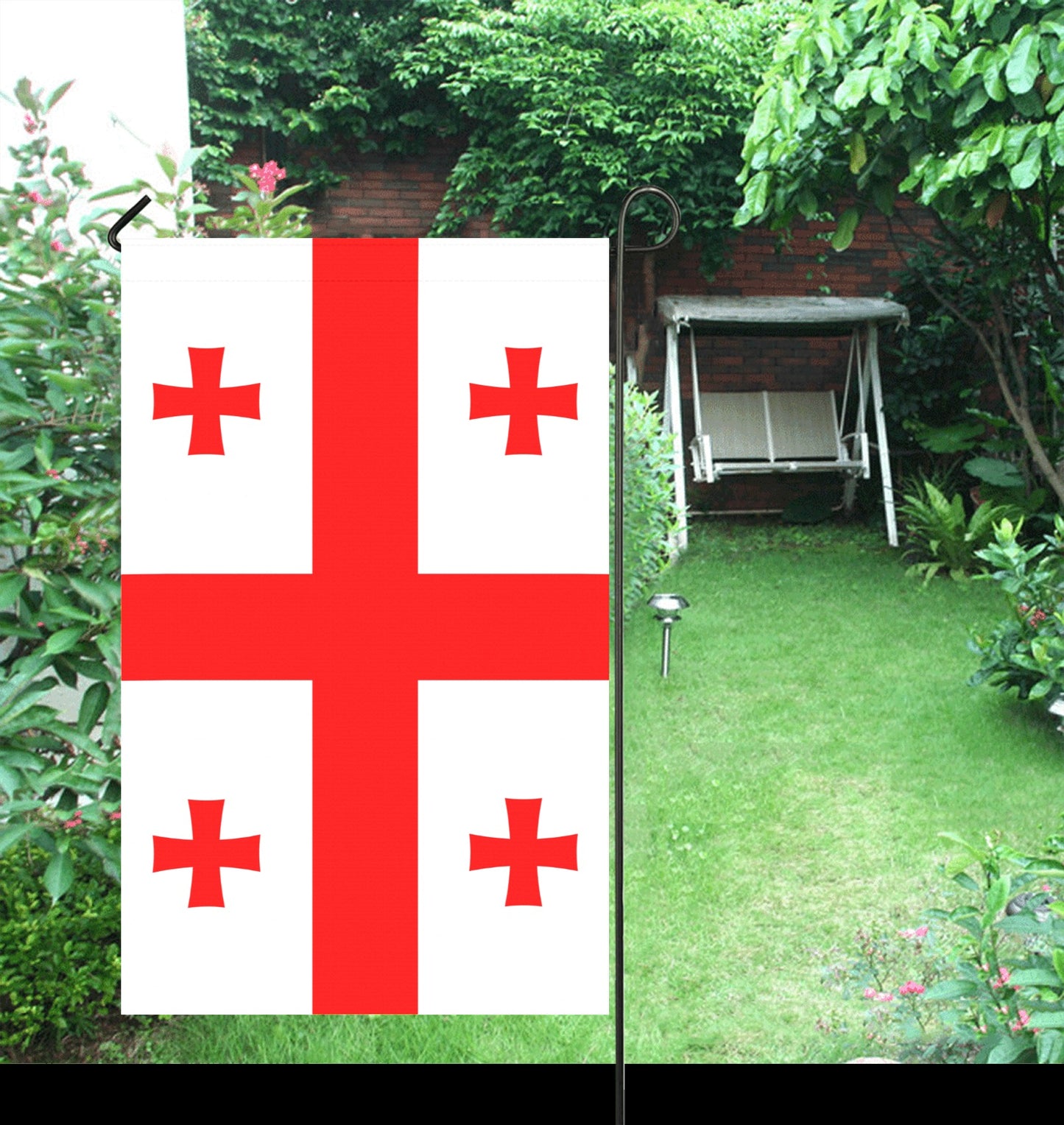 Luv My Flag garden decor with cross design, lush background.