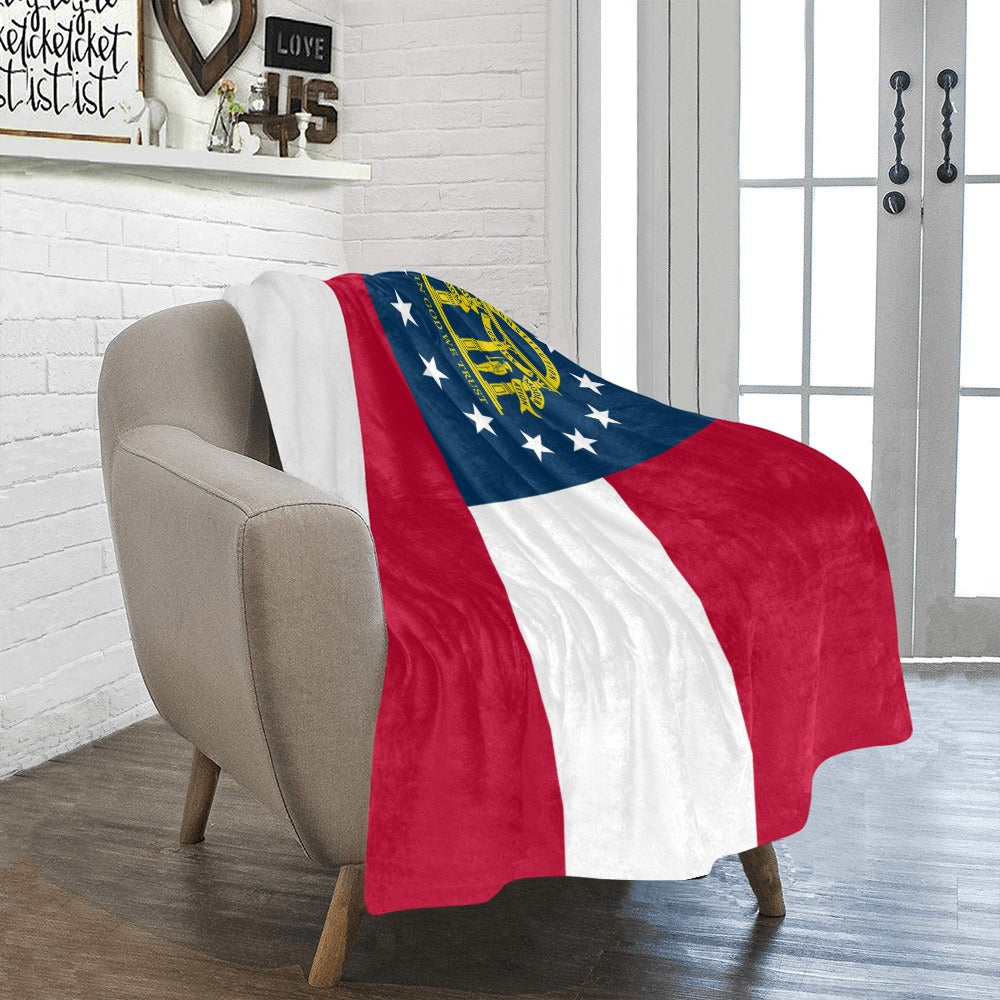 Cozy armchair draped with Luv My Flag Georgia blanket.