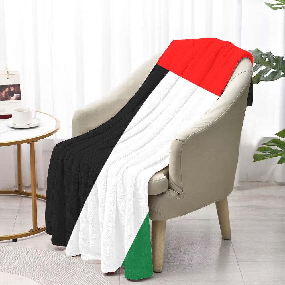 Cozy chair with Luv My Flag design blanket draped.