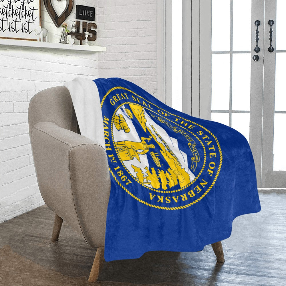 Cozy Nebraska flag blanket by Luv My Flag on chair.