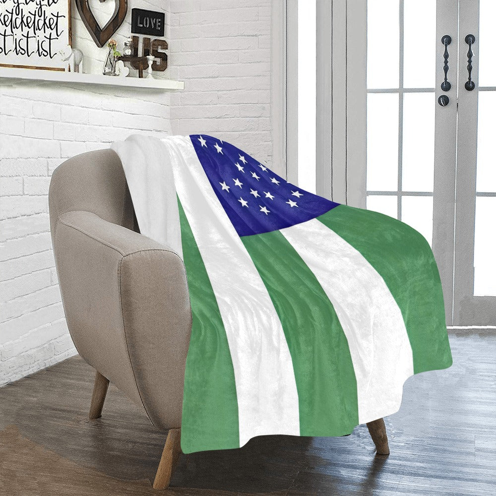 Cozy chair with Luv My Flag green striped blanket.