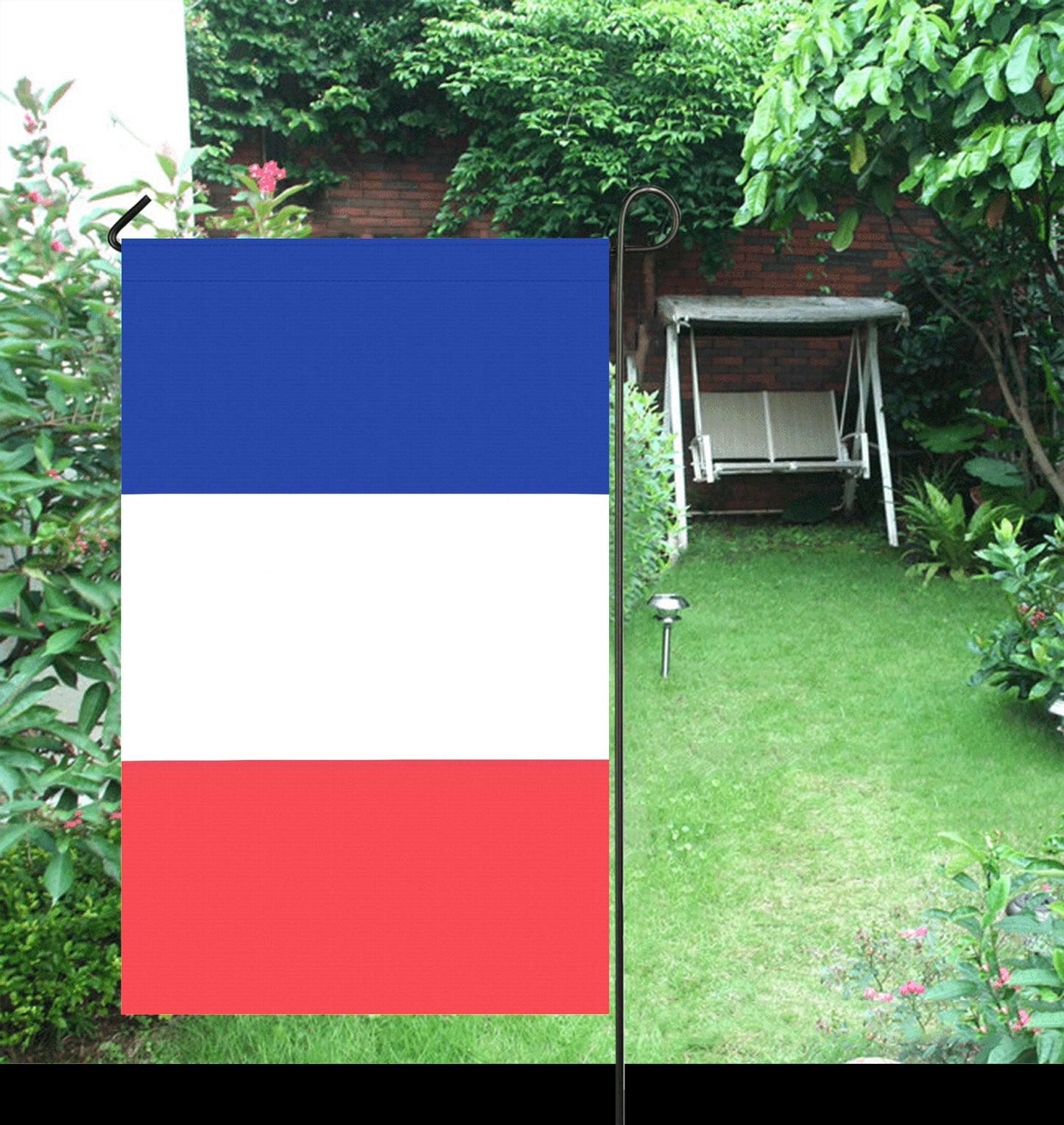 Garden scene with Luv My Flag tricolor flag displayed.