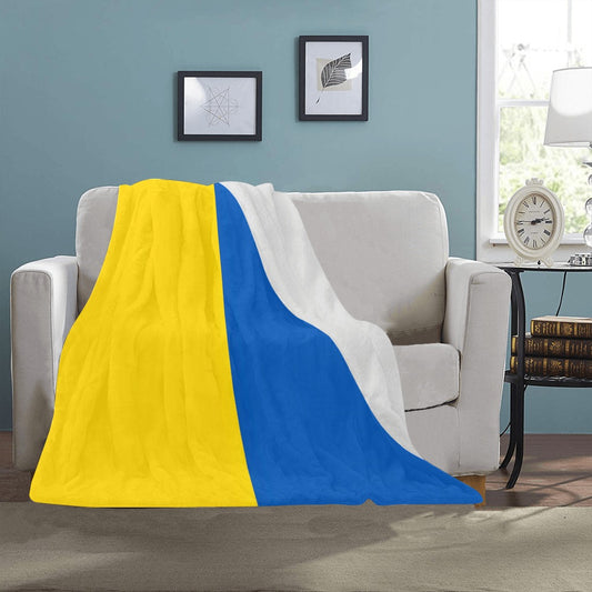 Luv My Flag blanket on sofa, yellow, blue, white.