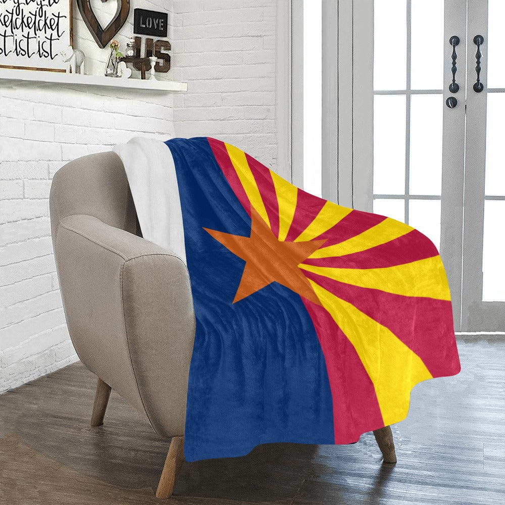 Cozy sofa with Luv My Flag Arizona-themed blanket draped.