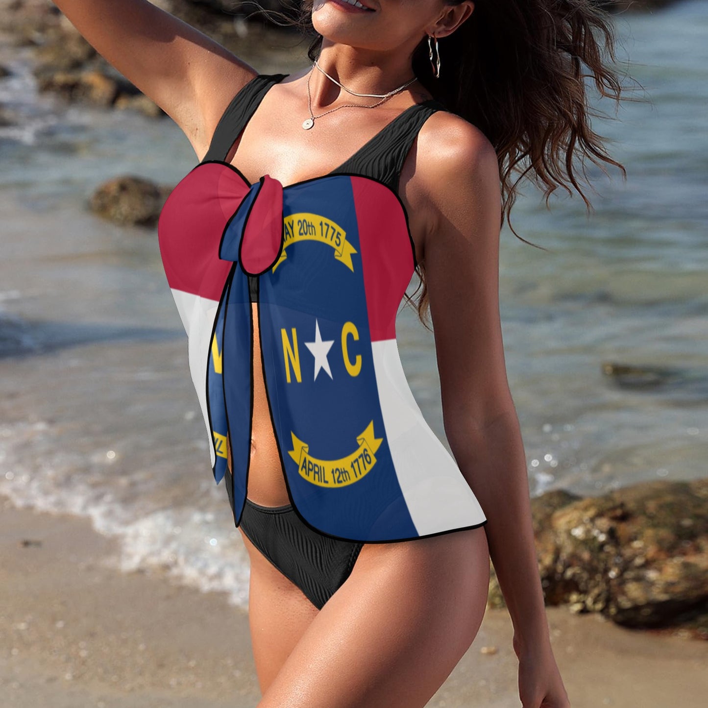 Woman wearing Luv My Flag swimsuit, beach background visible.