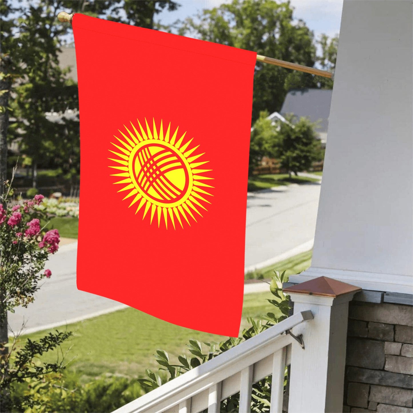 Red flag with yellow sun, displayed on porch. Luv My Flag.