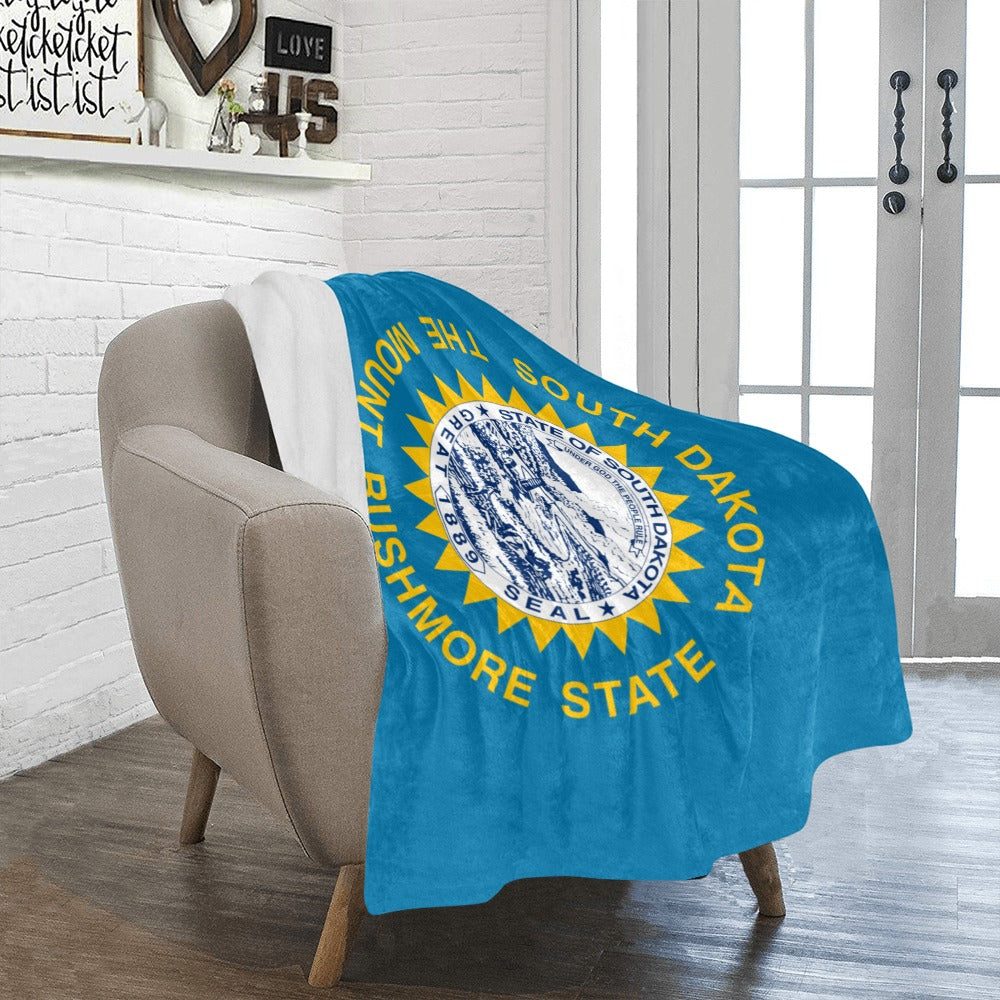 A cozy chair draped with Luv My Flag blanket.