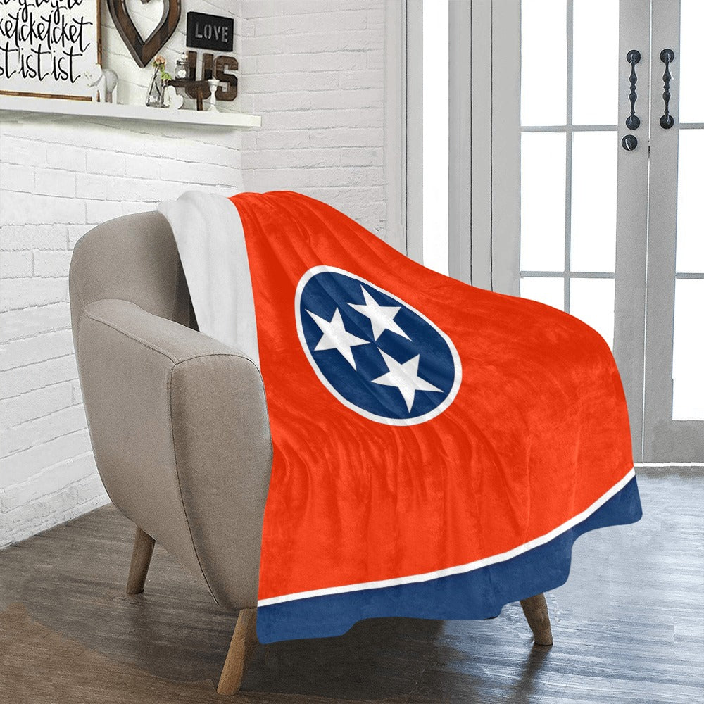 Cozy chair with Luv My Flag Tennessee-themed blanket.