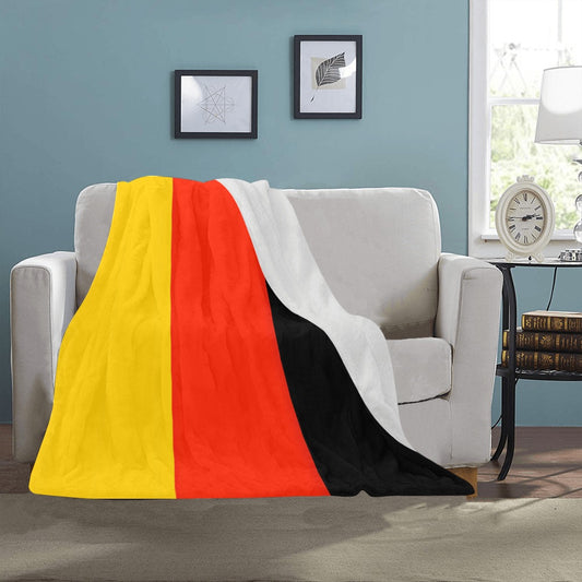Luv My Flag blanket on sofa, showcasing bold colors.