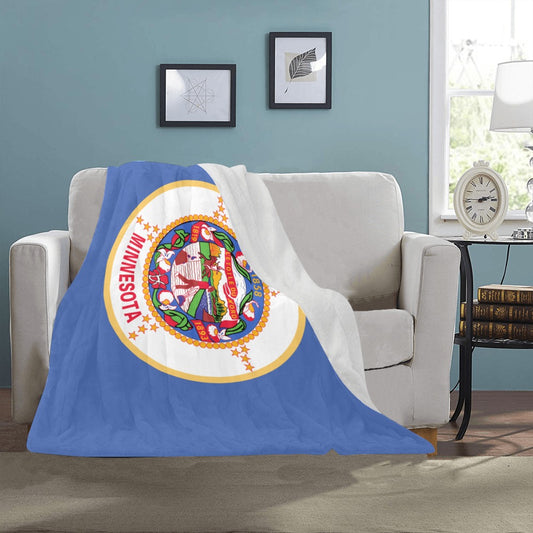 Cozy blanket featuring Minnesota flag on white couch. Luv My Flag.