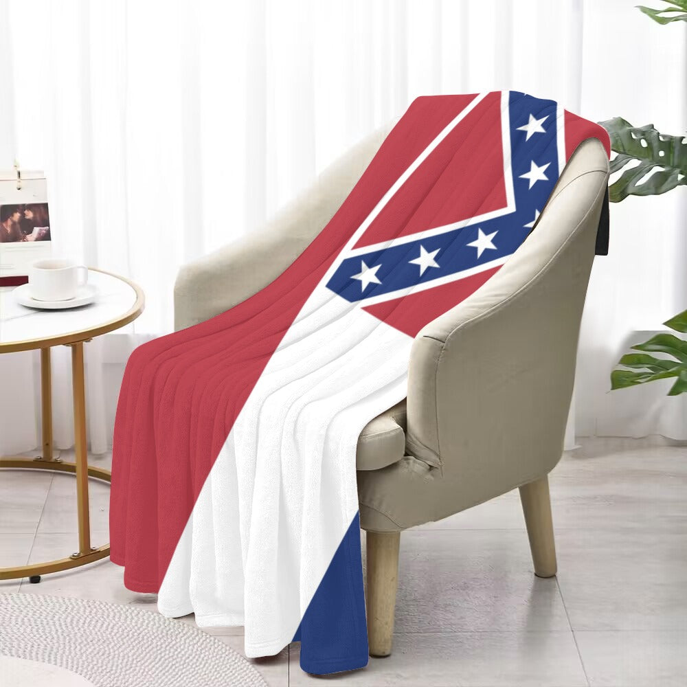 Cozy chair draped with Luv My Flag pattern blanket.