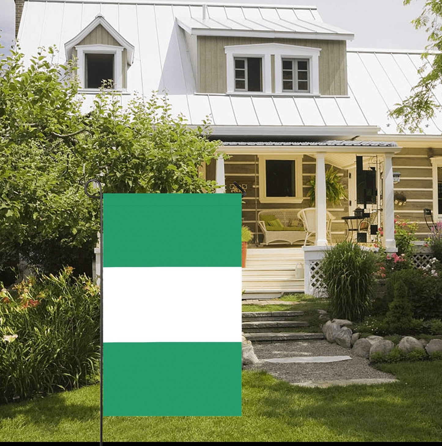 Green and white flag by Luv My Flag in garden.