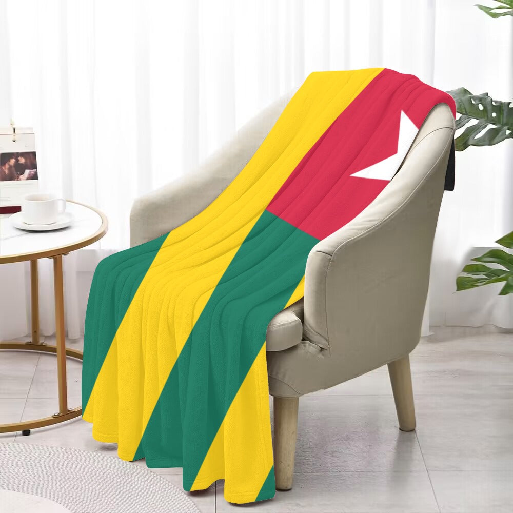 Cozy chair draped with Luv My Flag colorful blanket.
