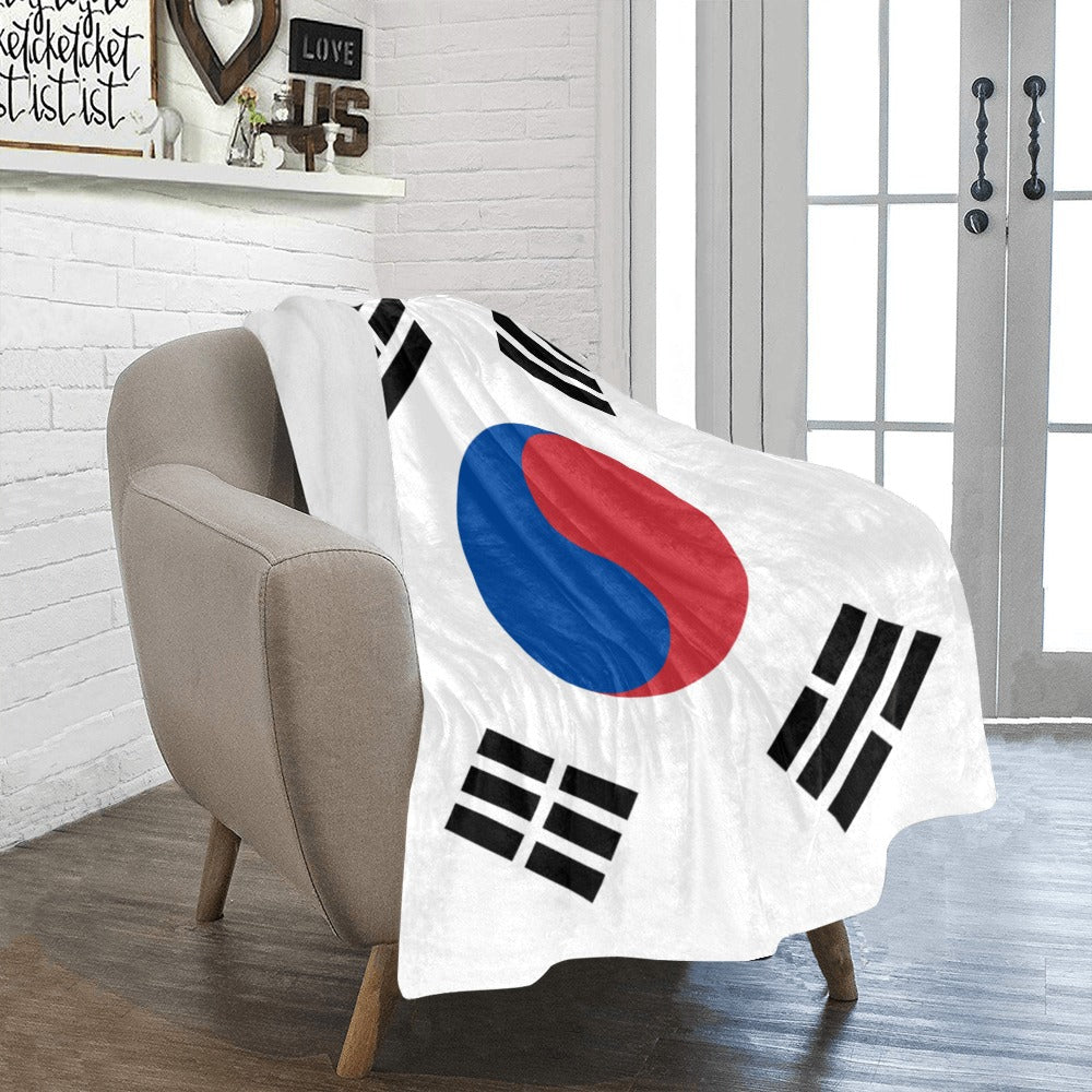 Cozy chair with Luv My Flag design blanket draped.